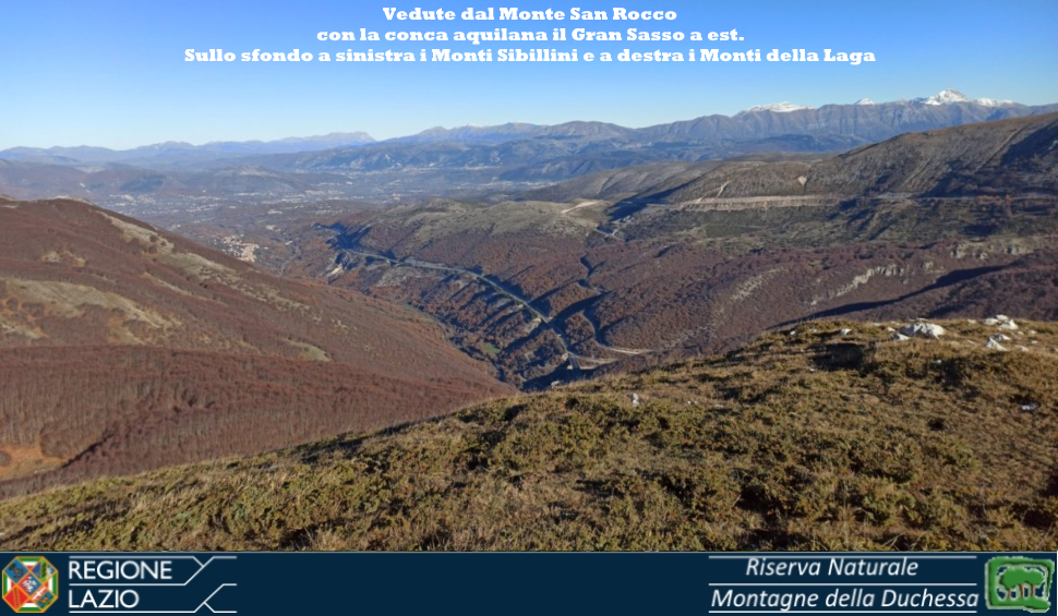 Foto 8: vedute da Monte San Rocco sulla Conca Aquilana. Sullo sfondo da sinistra i Sibillini, i Monti della Laga 
		  ed il Gran Sasso
